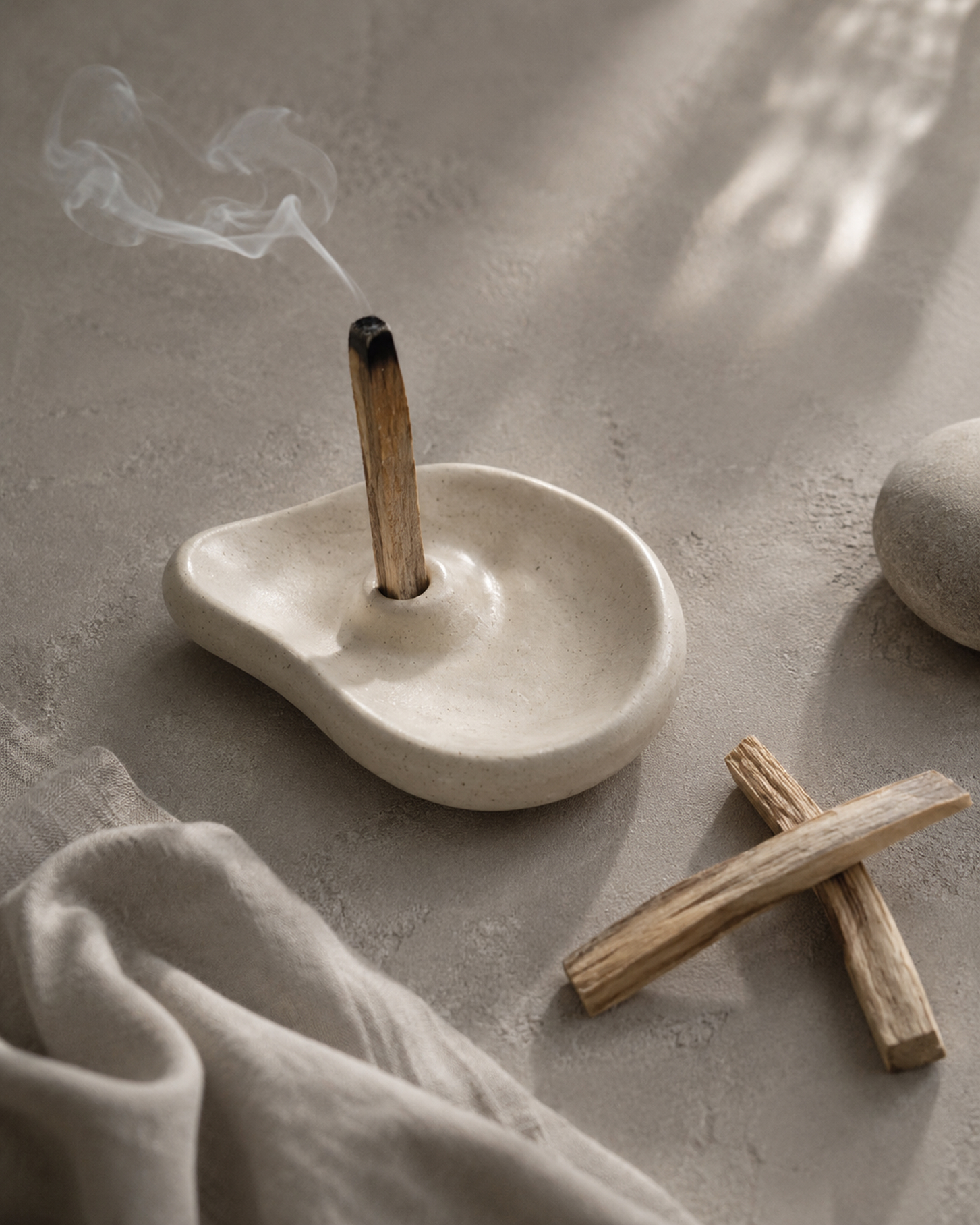 Palo santo smoke rising from a ceramic scent object